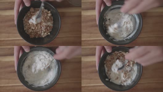 将格兰诺拉麦片和天然酸奶混合在一起作为早餐高清在线视频素材下载