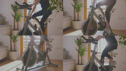 SLO MO女人调整健身自行车高清在线视频素材下载