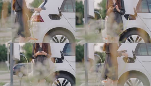 一个在等车充电时使用智能手机的女人高清在线视频素材下载