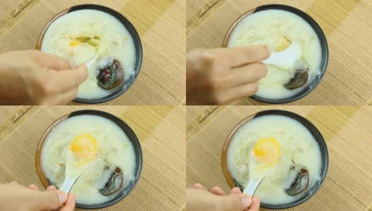 大米粥加鸡蛋在碗里高清在线视频素材下载