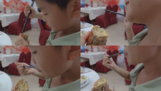 可爱的小男孩用黄油吃螃蟹高清在线视频素材下载