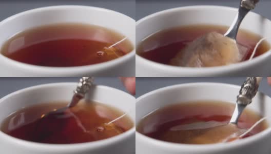 把红茶和茶包放在一个白色的杯子里搅拌高清在线视频素材下载