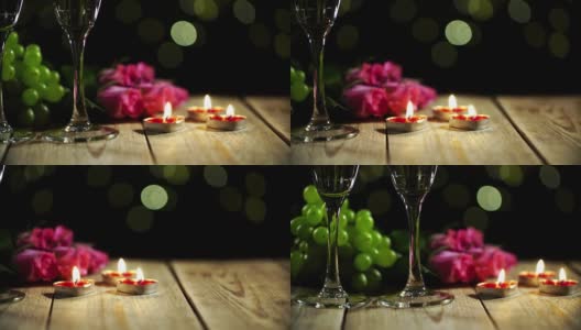 爱情静物在宏观上由燃烧的蜡烛和鲜花躺在葡萄与酒杯高清在线视频素材下载