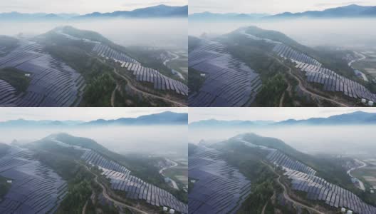 无人机在晨雾中观察山顶上的太阳能发电厂高清在线视频素材下载
