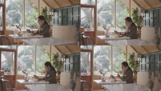 亚洲女商人在咖啡店用手机工作高清在线视频素材下载