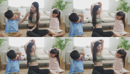妈妈带着孩子在家做伸展运动高清在线视频素材下载