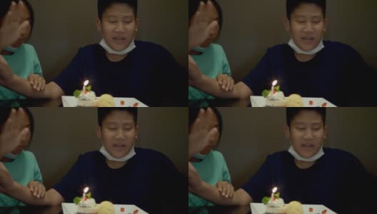 亚洲男孩和妹妹在餐厅吹生日蜡烛和冰淇淋蛋糕，生活理念。高清在线视频素材下载