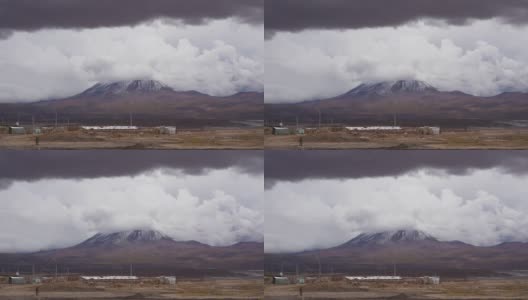 在多云的天气里，火山口附近的一个小居民点高清在线视频素材下载
