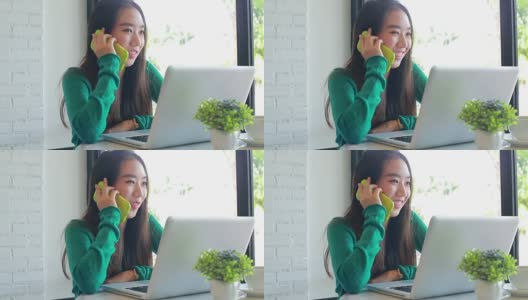 美丽的亚洲女孩在咖啡店讲手机高清在线视频素材下载