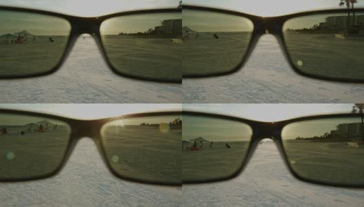 波夫看太阳镜日落太阳佛罗里达海滩镜头耀斑高清在线视频素材下载