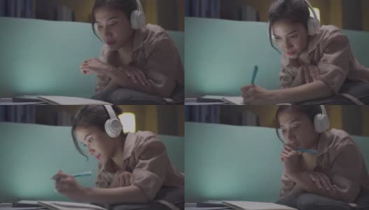年轻美丽的亚洲女子使用平板电脑，上网同时在家学习。高清在线视频素材下载