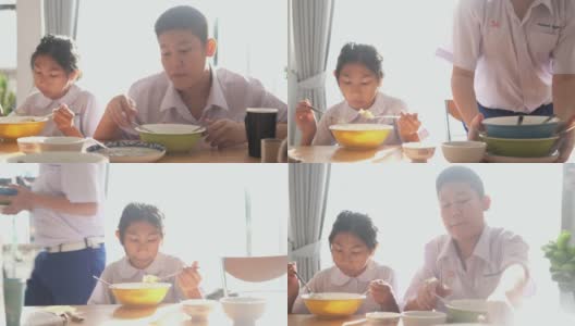 亚洲学生在上学前一起在家吃早餐。高清在线视频素材下载
