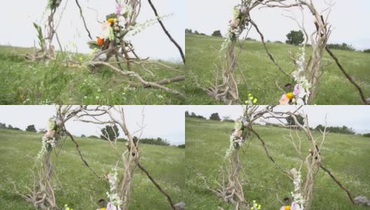 用树枝和鲜花装饰的婚礼拱门高清在线视频素材下载