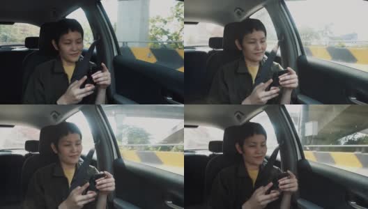 女人在车里用智能手机高清在线视频素材下载