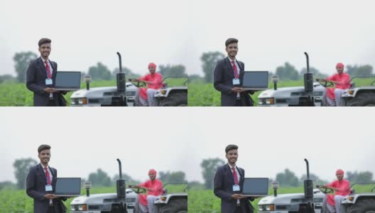 年轻的印度农学家或银行家与农民在农业领域展示笔记本电脑屏幕高清在线视频素材下载