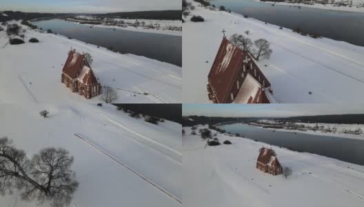 冬季航拍的独特的、真实的哥特式的施洗者圣约翰查布斯基斯老教堂位于Nemunas河岸边的山谷高清在线视频素材下载