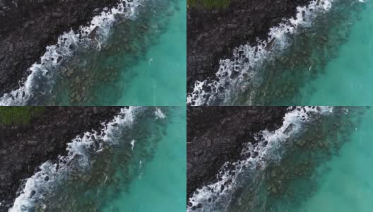 海浪撞击岩石的鸟瞰图高清在线视频素材下载