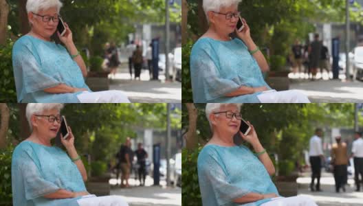 一位成熟的女士正在用智能手机打电话高清在线视频素材下载