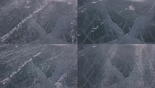 雪在冰面上飞舞。雪花在贝加尔湖的冰面上飞舞。冰非常美丽，有独特的裂缝。雪花闪耀着红光。在日落时分。高对比度。高清在线视频素材下载