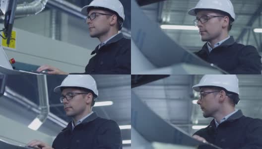 安全帽工程师在工厂安装数控机床高清在线视频素材下载