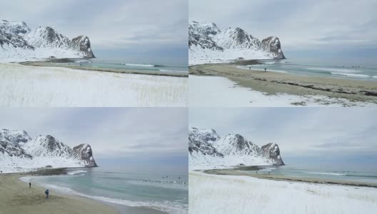 在挪威罗浮敦，飞越白雪皑皑的海滩，飞向碧波汹涌的大海。高清在线视频素材下载