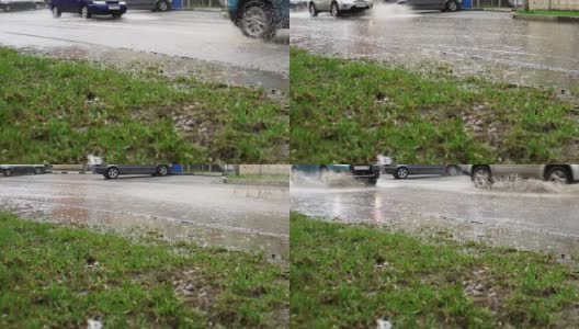 汽车在雨中行驶在被洪水淹没的道路上，慢镜头。高清在线视频素材下载