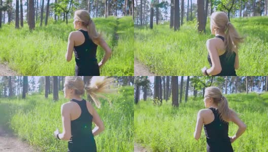 慢镜头拍摄了一个年轻的金发女郎穿着运动服，她在白天积极地在公园里跑步，他喜欢这种运动高清在线视频素材下载
