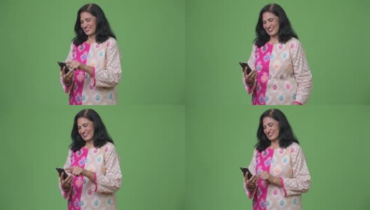 成熟快乐美丽的印度女人微笑着使用电话高清在线视频素材下载