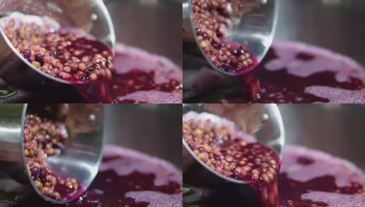 比格奈家用葡萄酒加工果汁用不锈钢勺子检查稠度高清在线视频素材下载