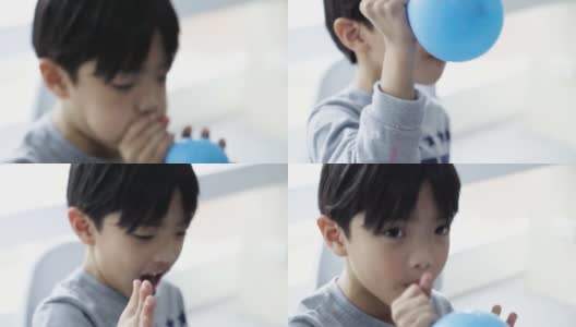小男孩吹气球高清在线视频素材下载