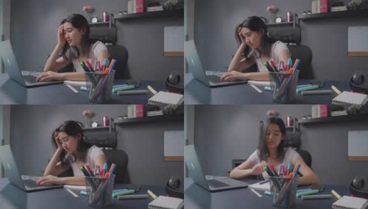 迷人的亚洲少女感到悲伤和沮丧后阅读和学习网上课程在她的笔记本电脑。在家上学的女孩坐在家里的客厅里，担心她的在线学习和教育考试成绩高清在线视频素材下载