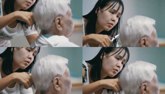 隔离在家:孙女在家剪祖母的头发高清在线视频素材下载