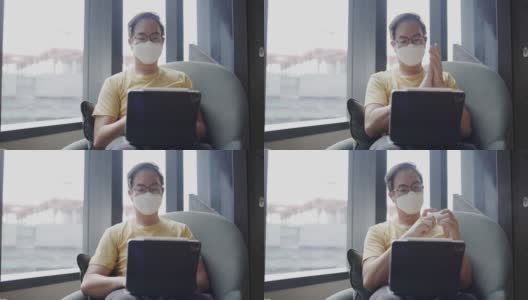 亚洲中年男子戴着眼镜，面罩，在办公空间使用笔记本电脑前喷酒精洗手。预防灰尘和COVID-19。与人保持社交距离。免费的网络高清在线视频素材下载