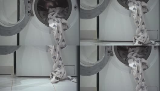 浴巾睡衣挂在浴室的洗衣机上高清在线视频素材下载