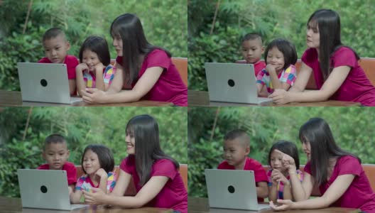 亚洲家庭喜欢在前院或后院里用笔记本电脑教学。高清在线视频素材下载
