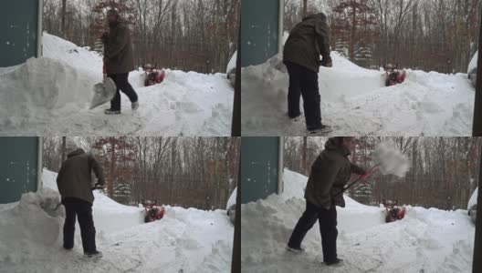 一场冬季暴风雪过后，一名男子正在清理车库和车道的出口。高清在线视频素材下载