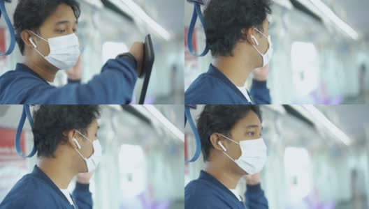 亚洲男子戴着防护口罩乘坐地铁。高清在线视频素材下载