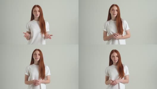肖像自信漂亮的年轻女子说话和微笑看着相机，站在白色孤立的背景在工作室。高清在线视频素材下载