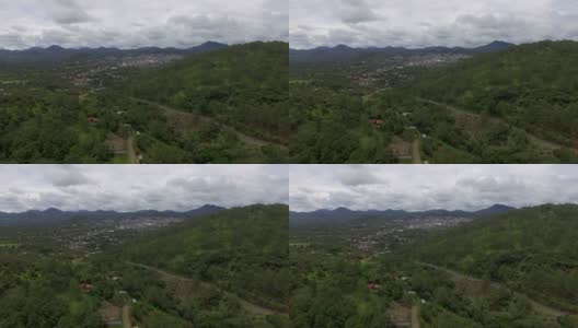 一架无人机拍摄的墨西哥一个被郁郁葱葱的树木包围的山城高清在线视频素材下载