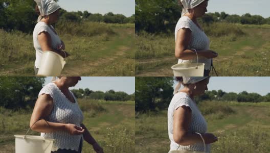 中景一个跑步的乡村妇女的头和一个空塑料桶在手里高清在线视频素材下载