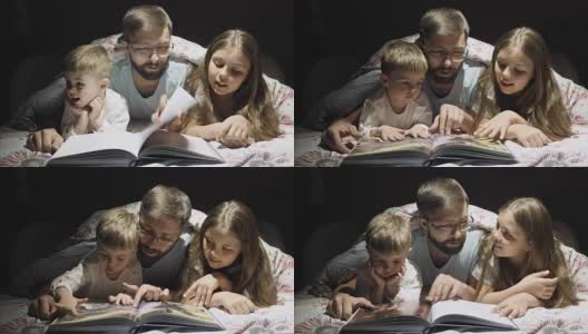 慈爱的父亲在晚上给孩子们读童话故事高清在线视频素材下载