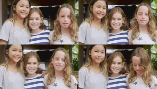三个年轻女孩微笑着看着镜头的不同团体的肖像高清在线视频素材下载