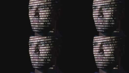 一个长着胡子的成年男子程序员看着显示器屏幕，而二进制代码字符投射在他的脸上高清在线视频素材下载