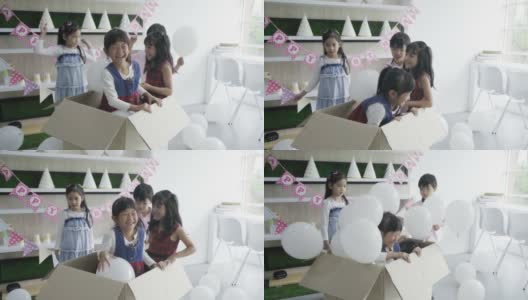 小男孩和小女孩在老师的聚会上玩气球高清在线视频素材下载