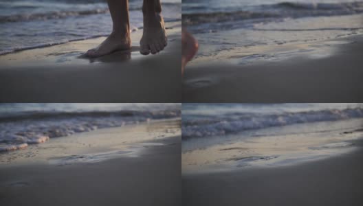 脚在海边的沙滩上留下痕迹，海水冲走了这些痕迹，近处，慢镜头高清在线视频素材下载
