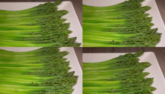 绿色的芦笋放在一个长长的白色盘子里高清在线视频素材下载