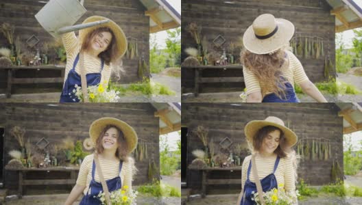 戴着帽子，带着袋装花的女士给房子附近的植物浇水高清在线视频素材下载
