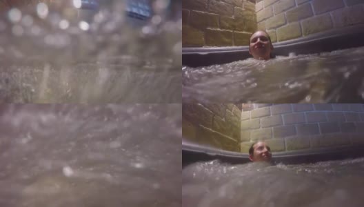 男人坐在热水浴缸里享受水疗按摩高清在线视频素材下载