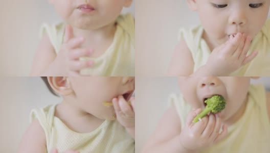 特写-可爱的小女孩正在用手吃西兰花高清在线视频素材下载