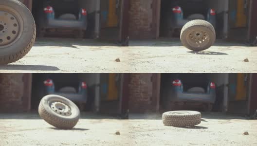 汽车车轮在停在车库的汽车前面的地面上滚动高清在线视频素材下载